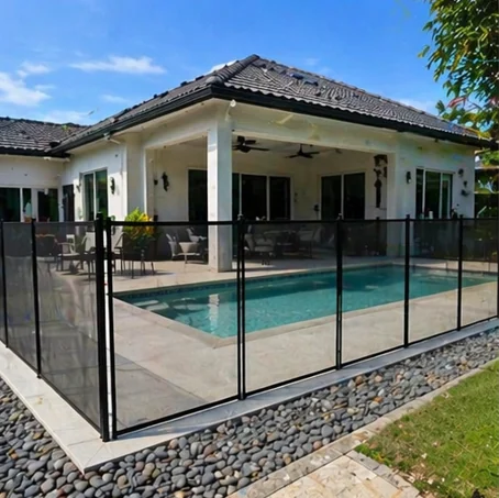 Removable mesh pool fence around a backyard swimming pool